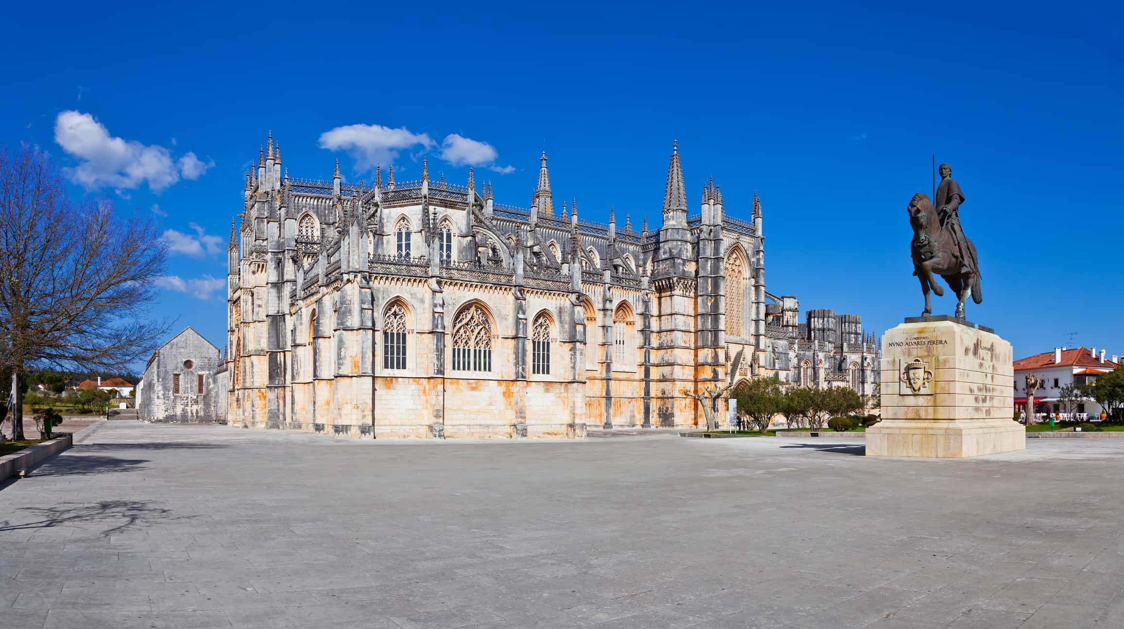 Monastery of Batalha aka Santa Maria da Vitoria Abbey with the statue of medieval hero knight Nuno Alvares Pereira.