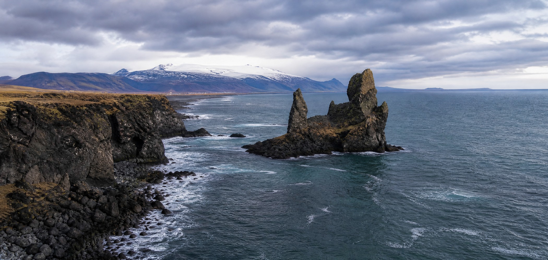 Londrangar sea stacks and black lava cliffs on Iceland’s Snaefellsnes Peninsula.