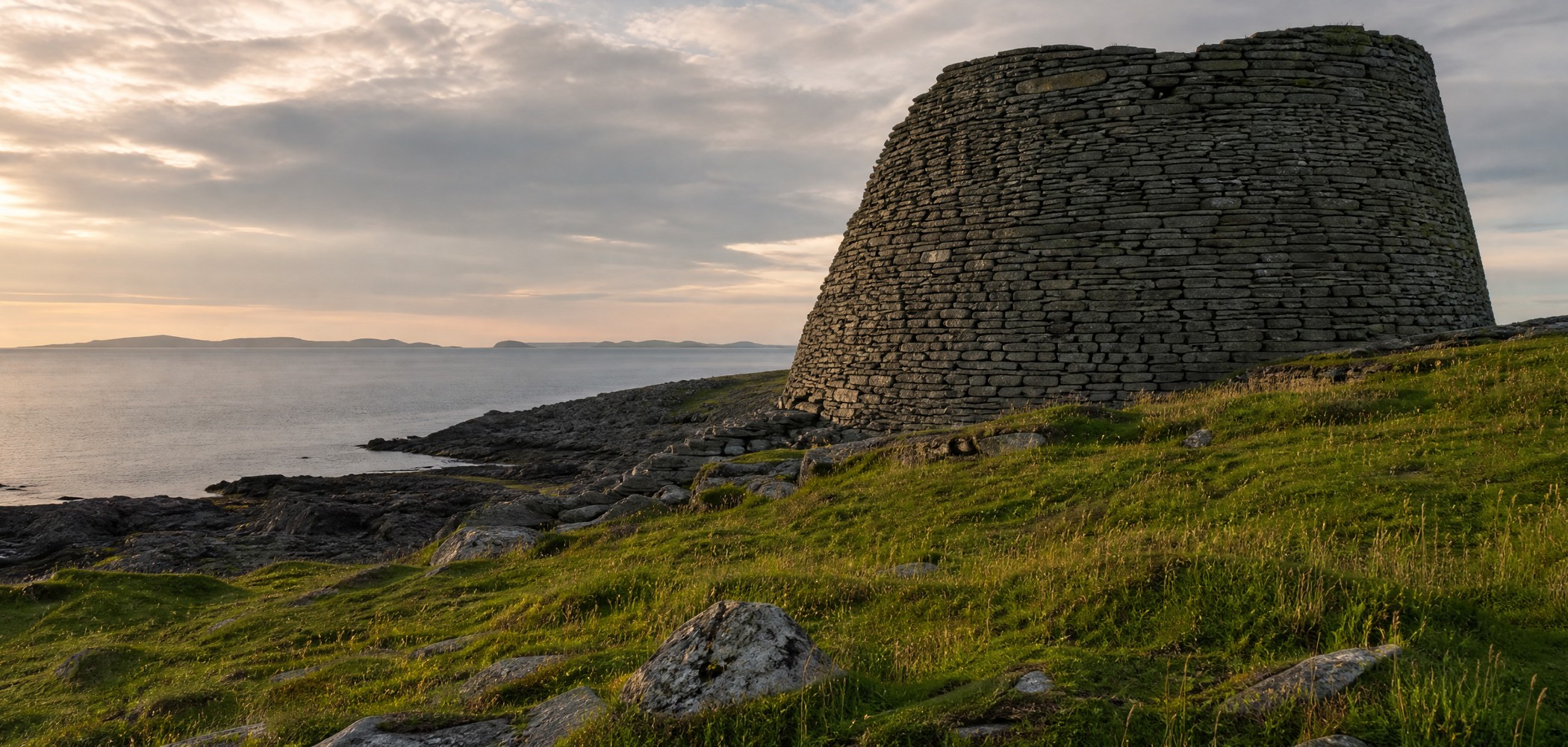 Mousa Broch on a grassy coast above the sea in Shetland.