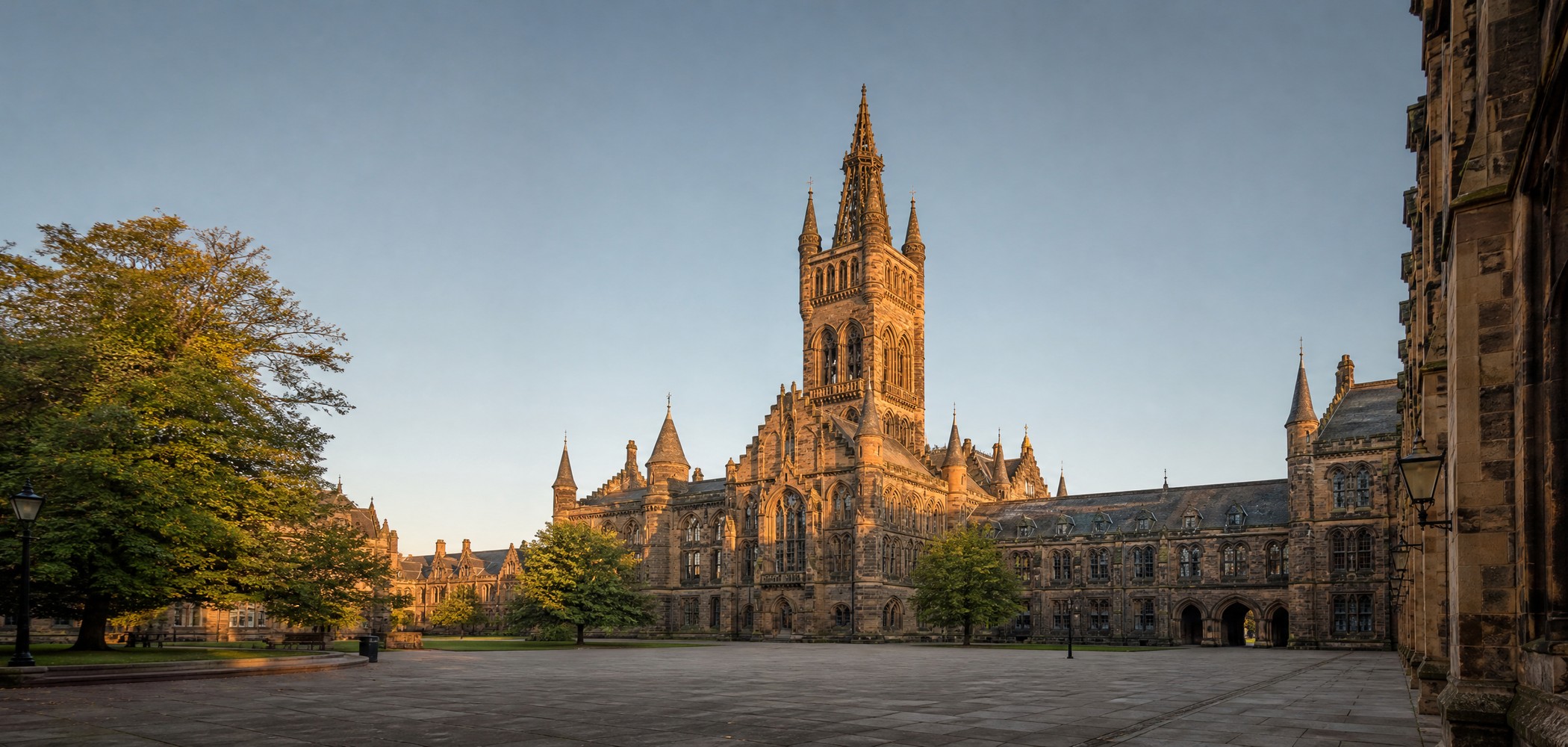 University of Glasgow Gothic Revival tower and empty stone quadrangle.