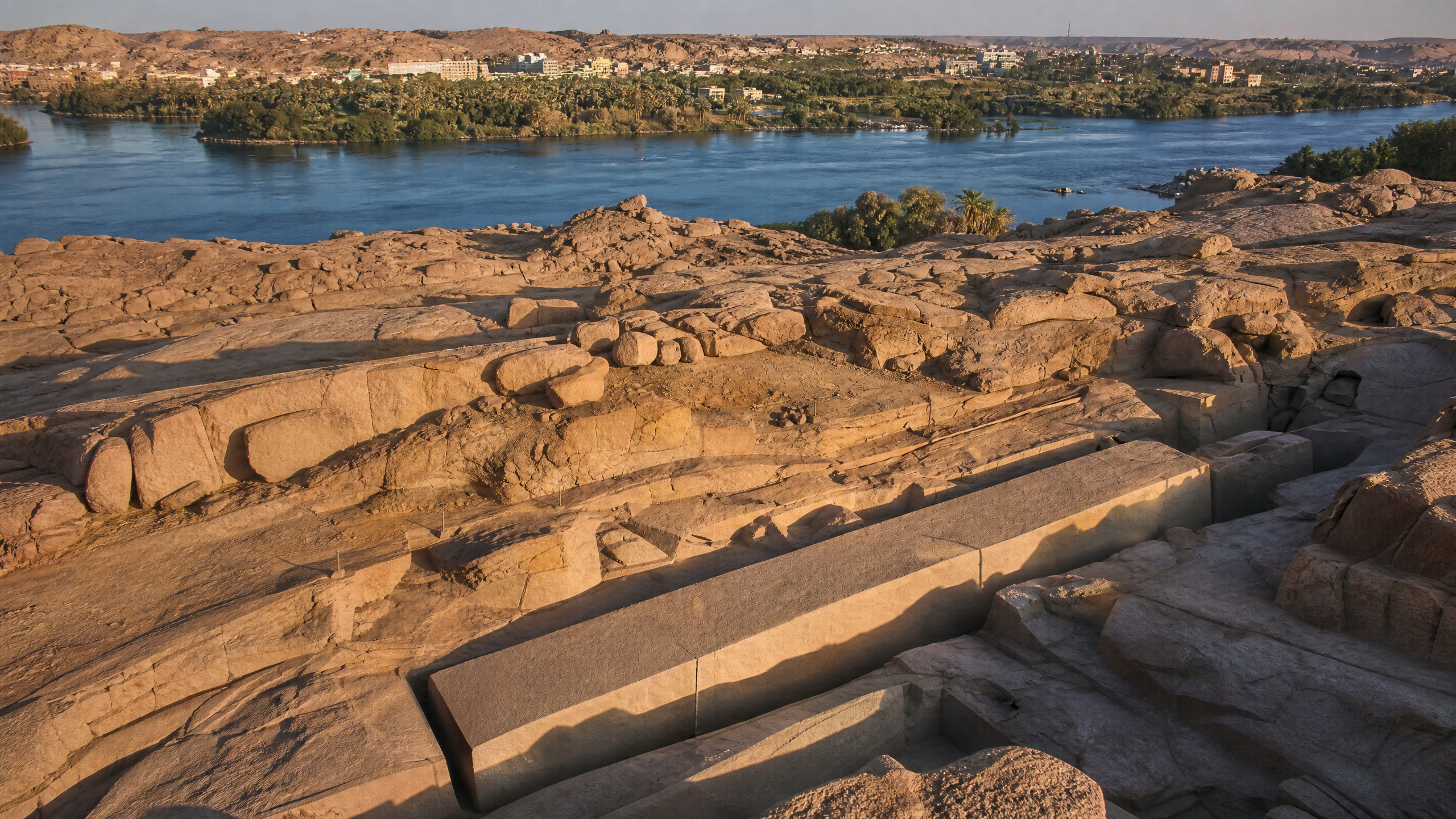 Wide view of the Aswan granite quarry and the Nile beyond, with the Unfinished Obelisk lying in its quarry bed