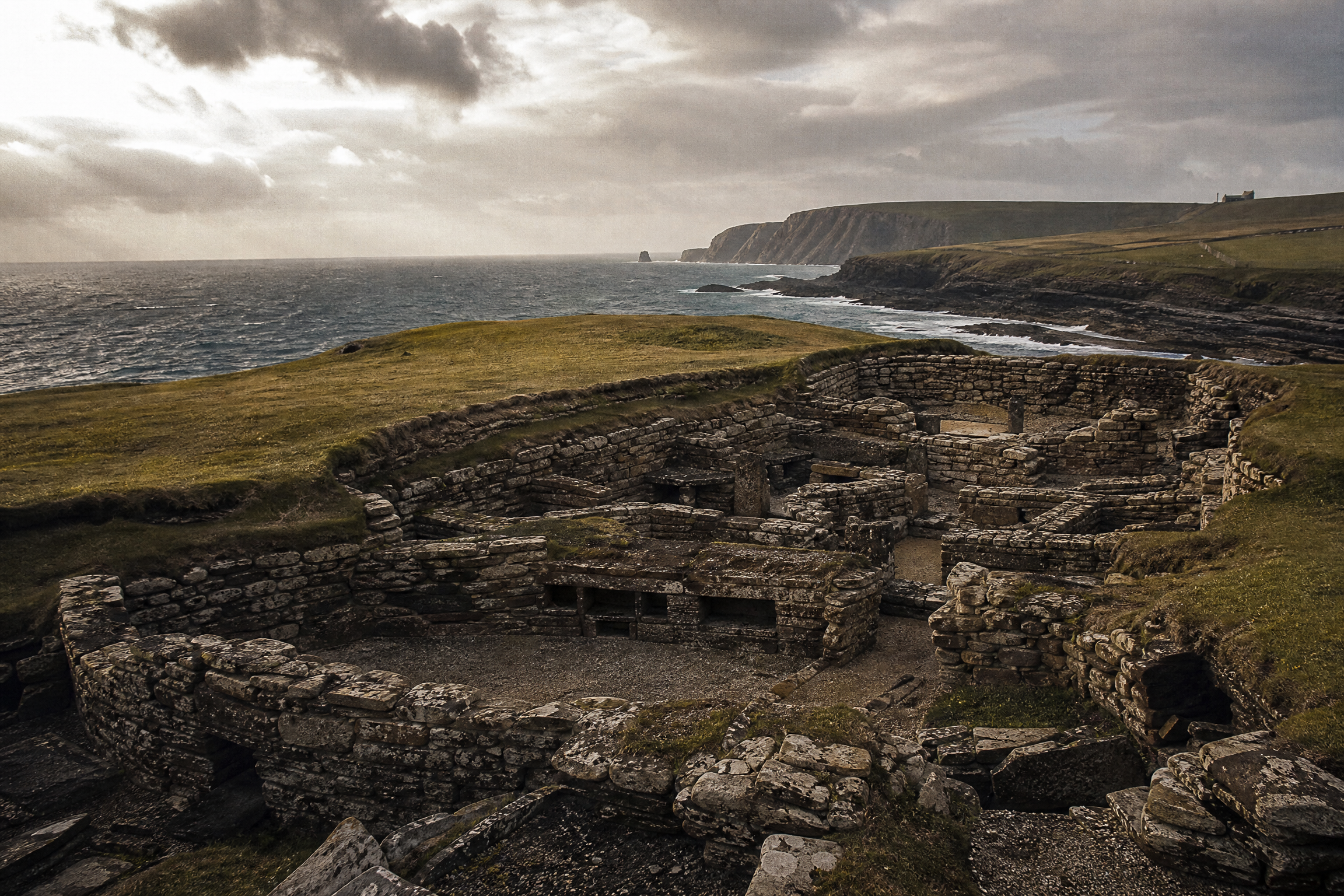 Jarlshof archaeological site, Shetland, showing layered Bronze Age, Iron Age and Norse ruins on a coastal headland, Scotland