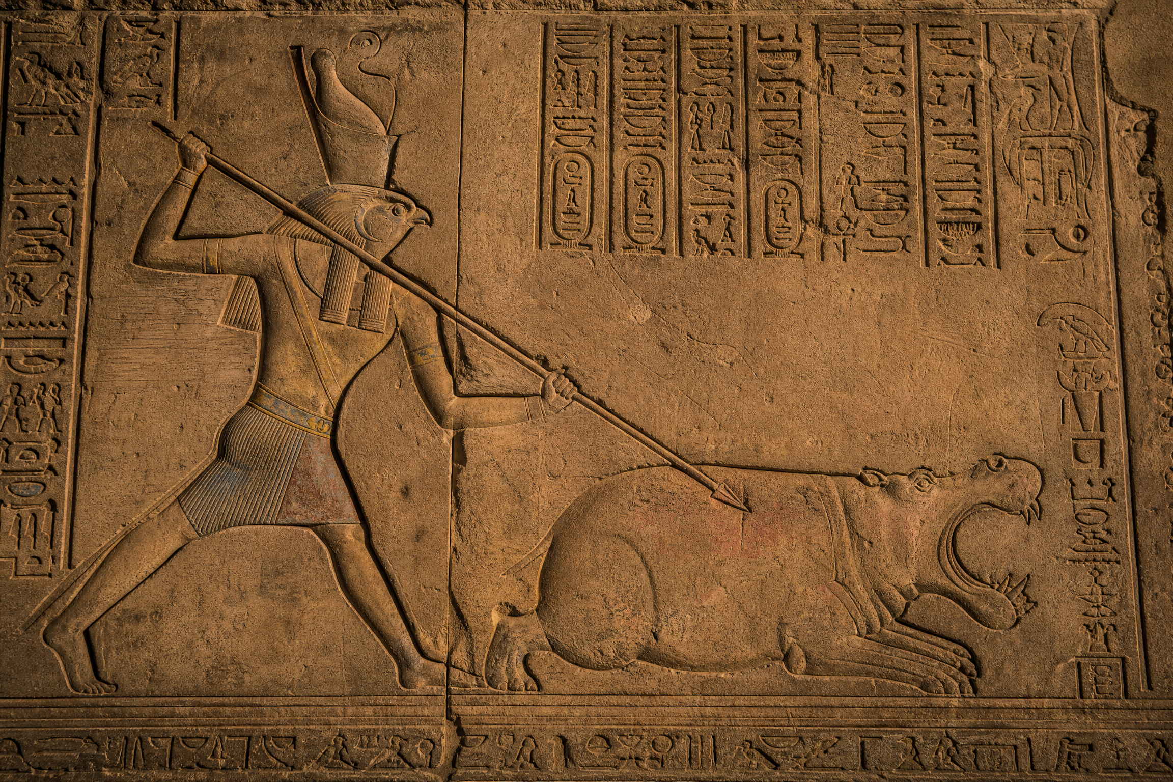 Hieroglyphic relief carving at Edfu Temple depicting the mythic battle between Horus and Seth