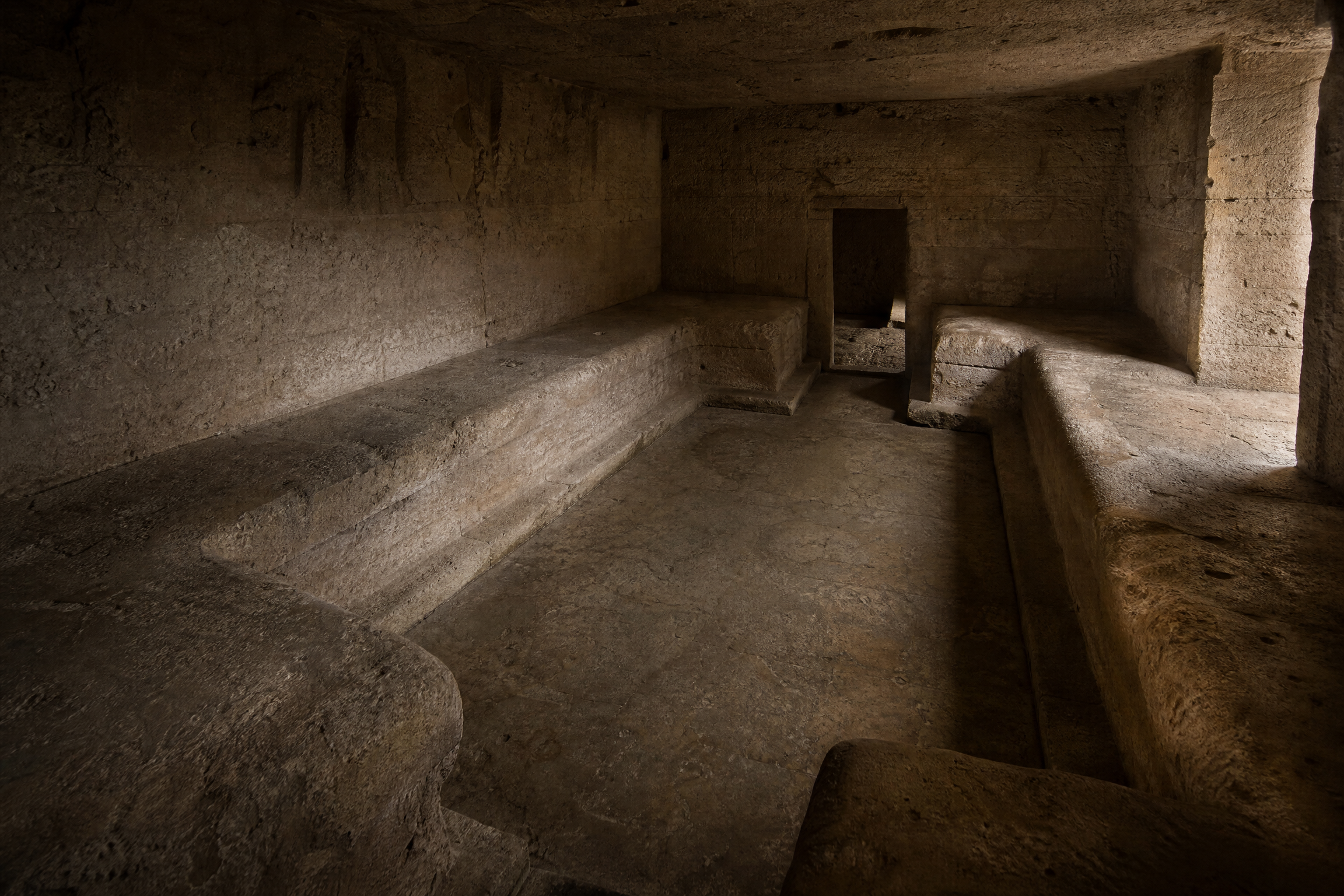Stone banqueting couches in the triclinium of the Catacombs of Kom el Shoqafa, Alexandria