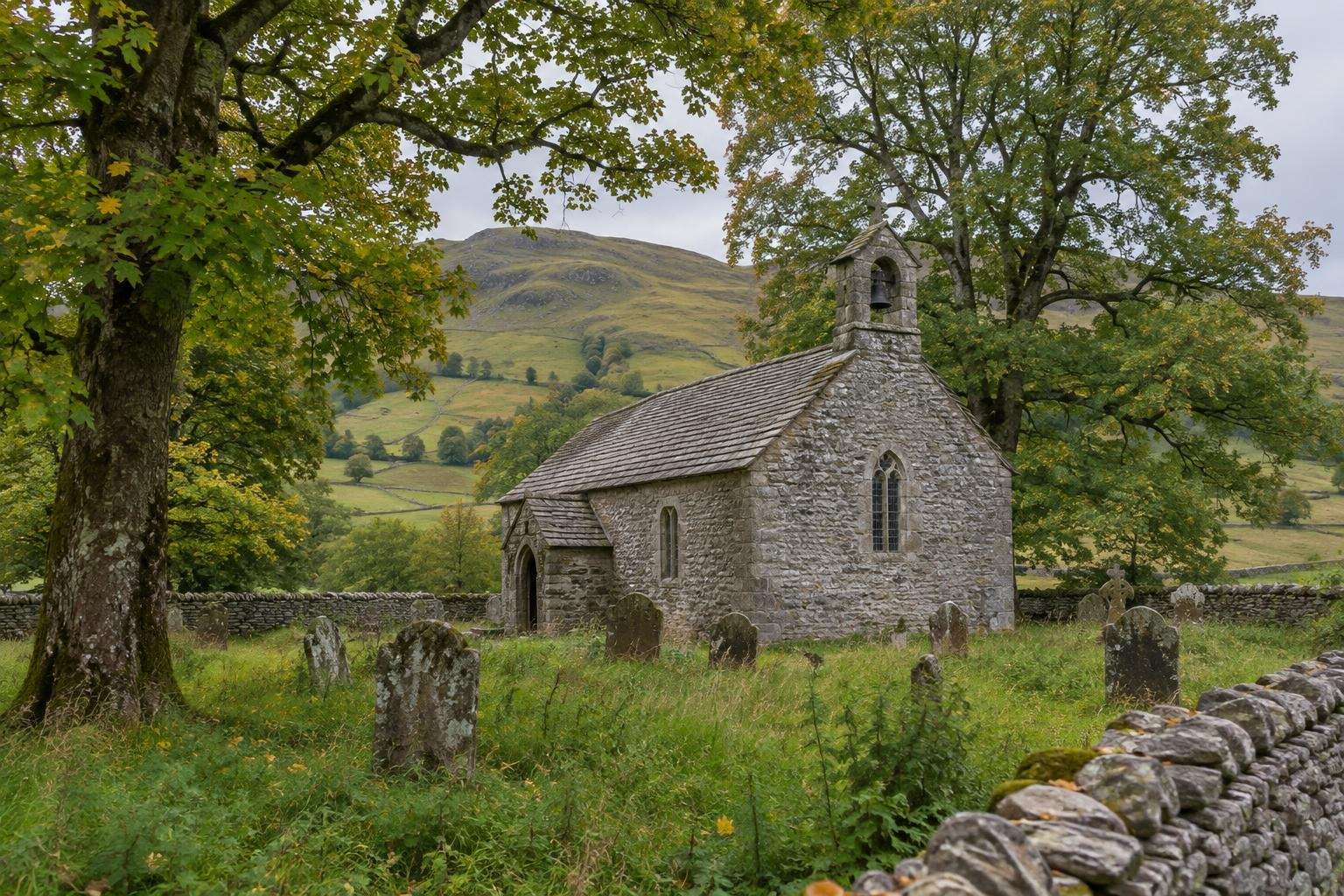 The small stone church and walled churchyard at Chapel-le-Dale in the Yorkshire Dales, near the Ribblehead Viaduct