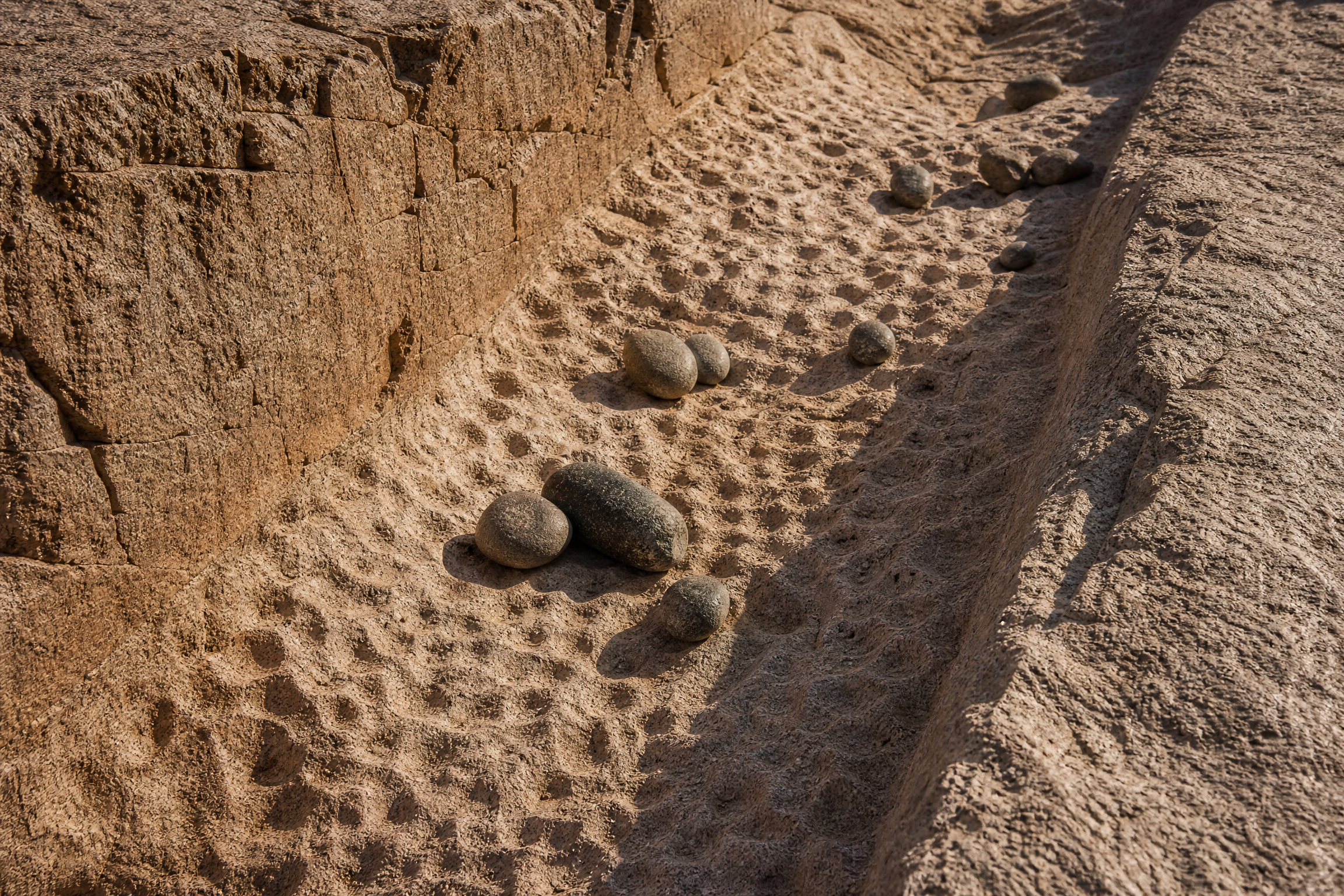 Close-up of ancient tool marks and dolerite pounding stones on the granite surface of the Unfinished Obelisk