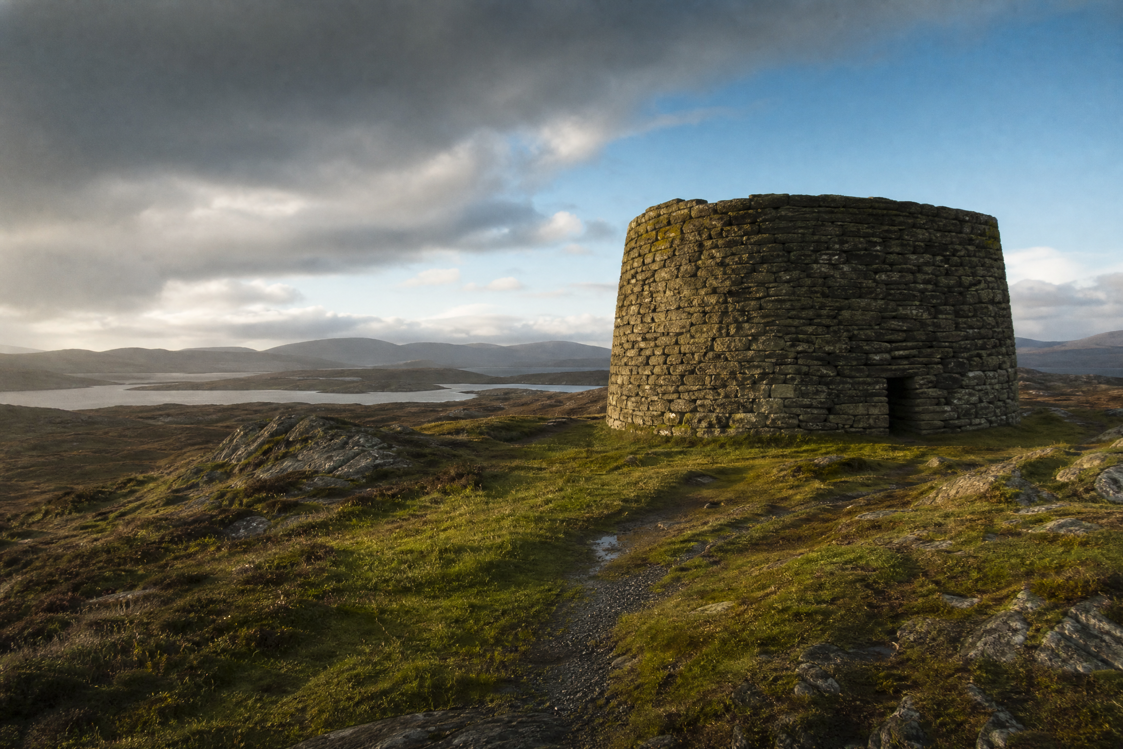 Low-angle exterior view of Carloway Broch rising above the Lewis moorland, Scotland