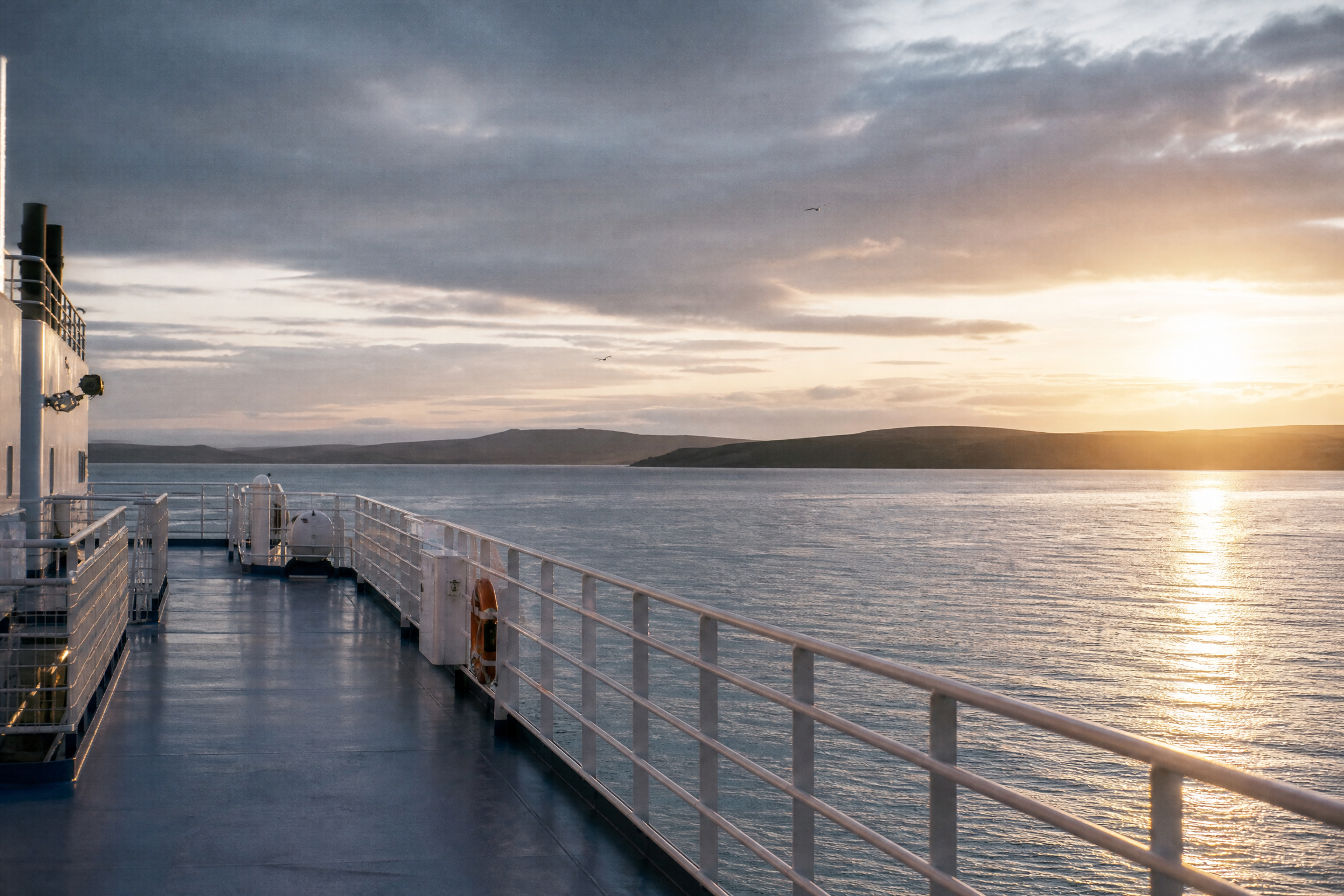 Open ferry deck at sunrise over the northern sea approaching Shetland