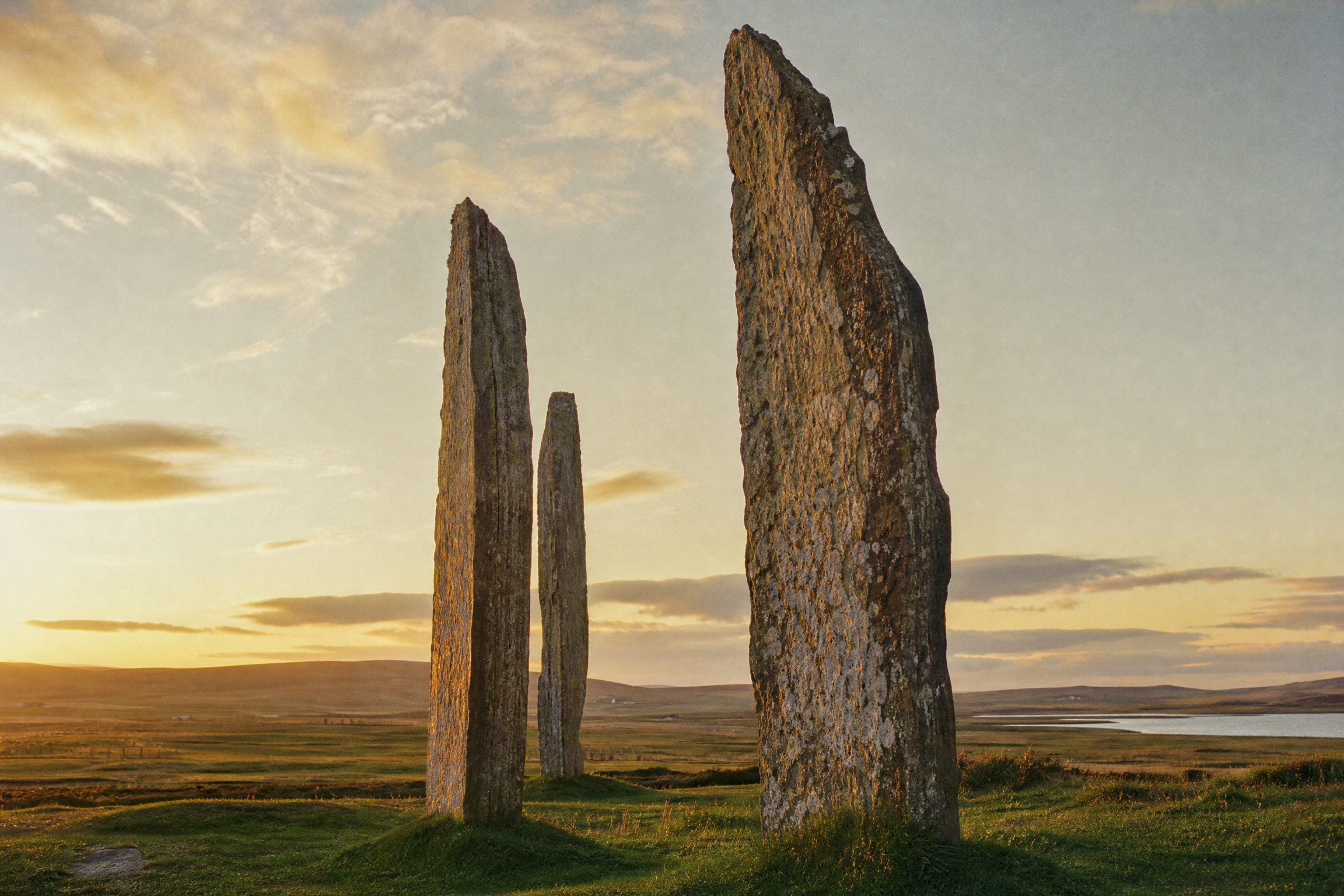Close-up of the lichen-covered megaliths at the Standing Stones of Stenness, Orkney, at golden hour